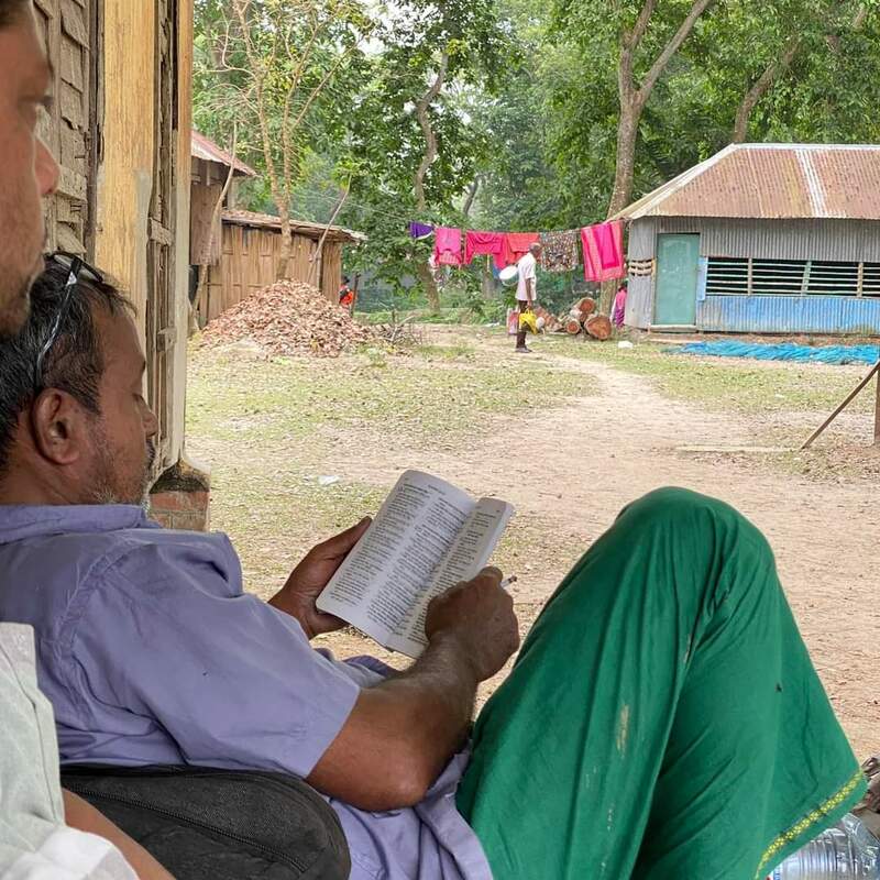 Villager reading Bible