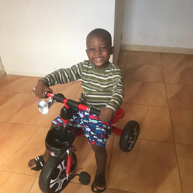 House of Love child with a new tricycle