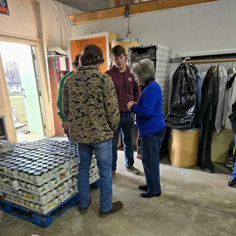 Janice Humble praying with FFA Members that brough donated food